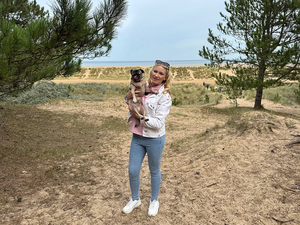 Emma Johnson from Dog Owner's Club with her lovely Pug at Holkham beach